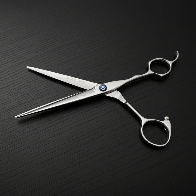 Silver hair scissors on a black oak textured background