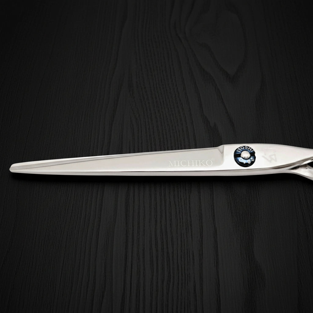 Hair-cutting scissors with a brand logo on a black oak textured background