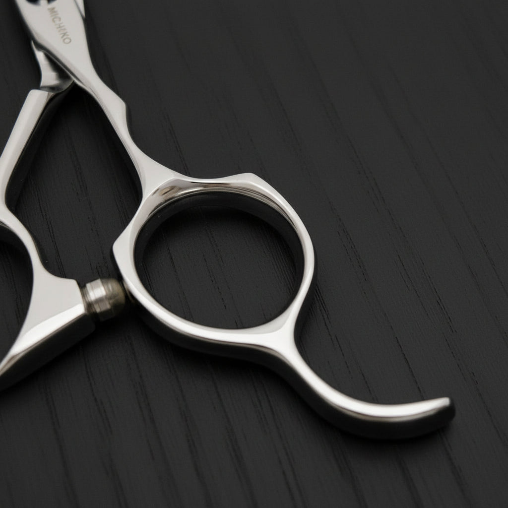 Close-up of a pair of silver scissors on a black oak textured background