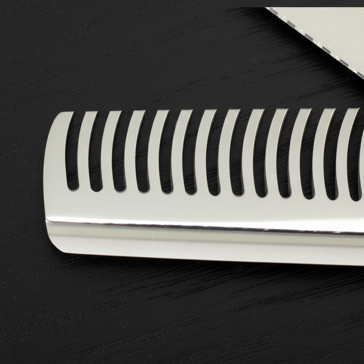 Close-up of hair thinning shears theeth blade on a black surface
