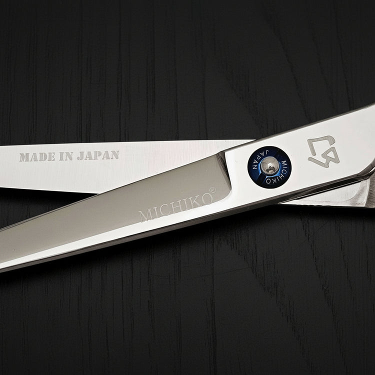 Professional Japanese hair cutting shears with precision blade and ergonomic design, made in Japan.