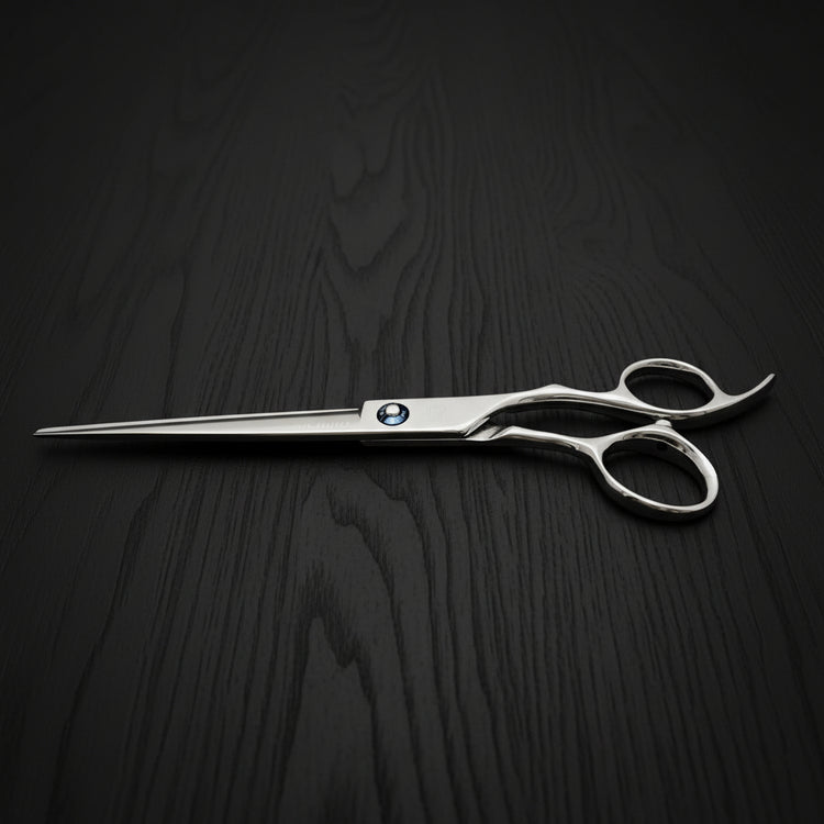 Silver hair scissors with a MICHIKO logo on a black oak textured background