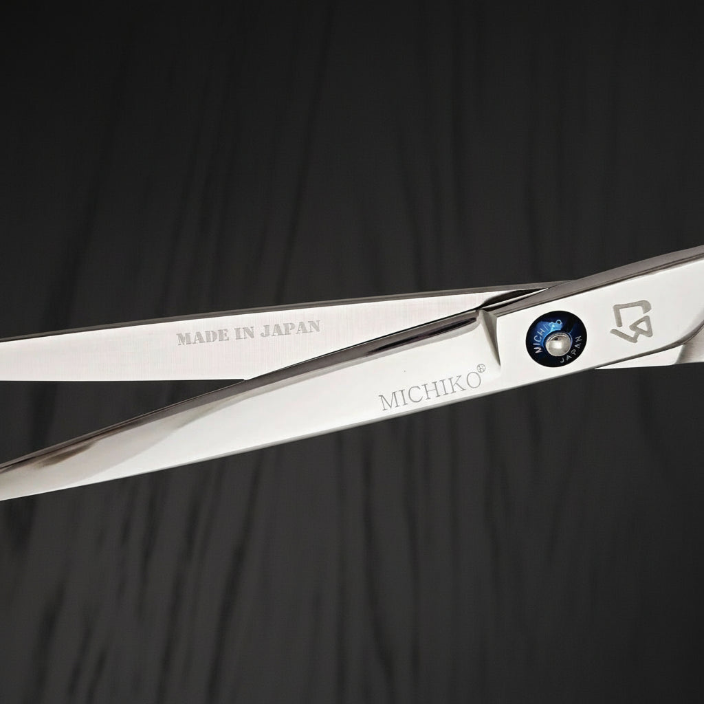 Hair shears with 'MICHIKO' branding on a black oak textured background