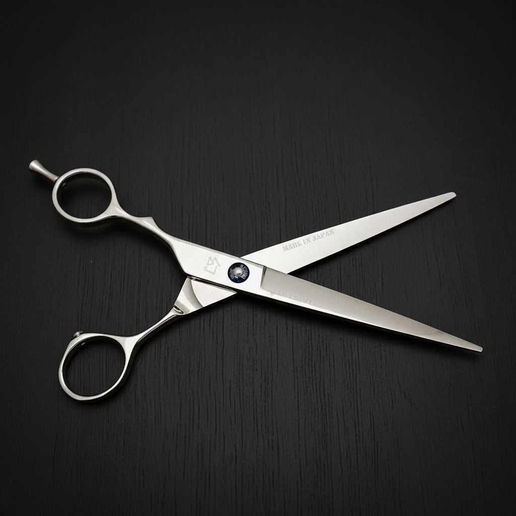 Stainless steel hair cutting shears on a black oak textured background