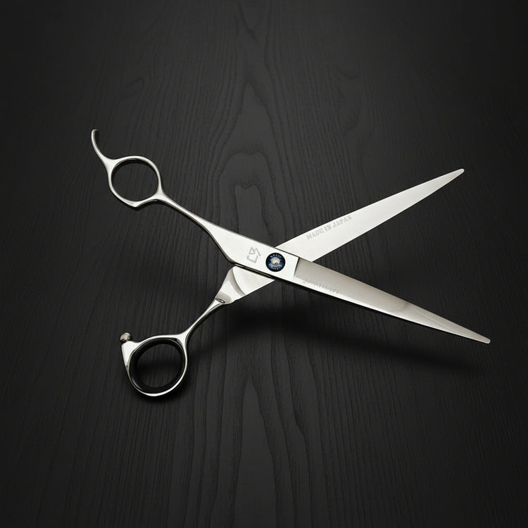 Hair cutting shears on a black oak textured background