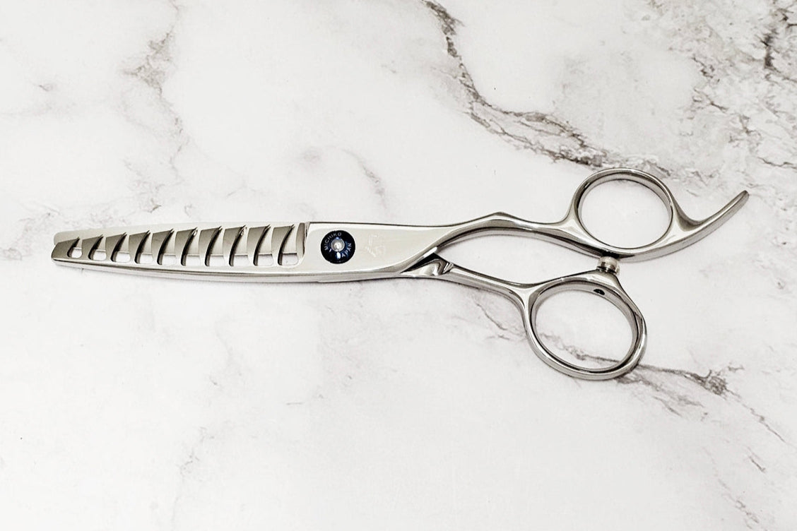 Hair shears on a marble surface