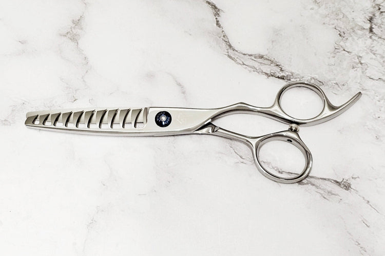 Hair shears on a marble surface
