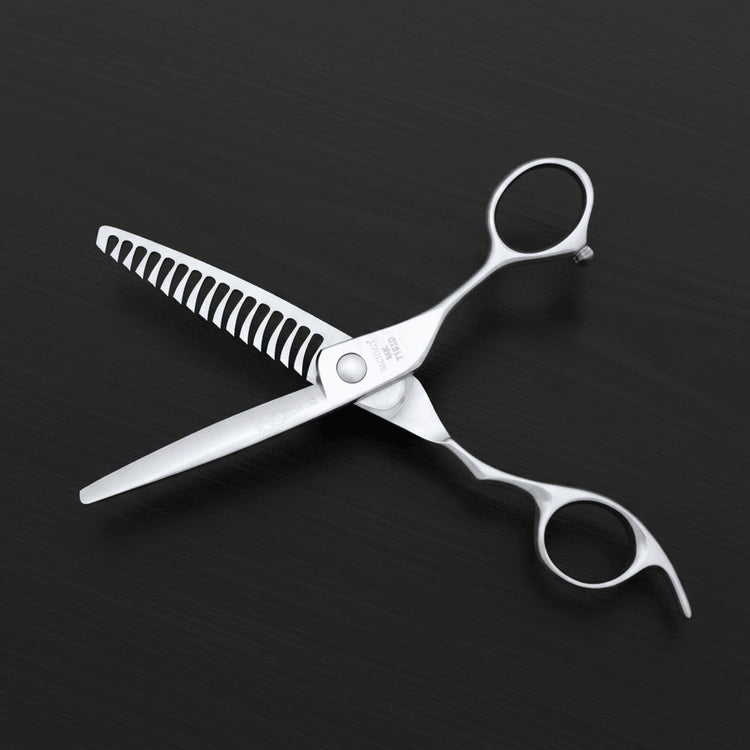 Hair texturizing scissors are shown on a dark textured background in an open position.