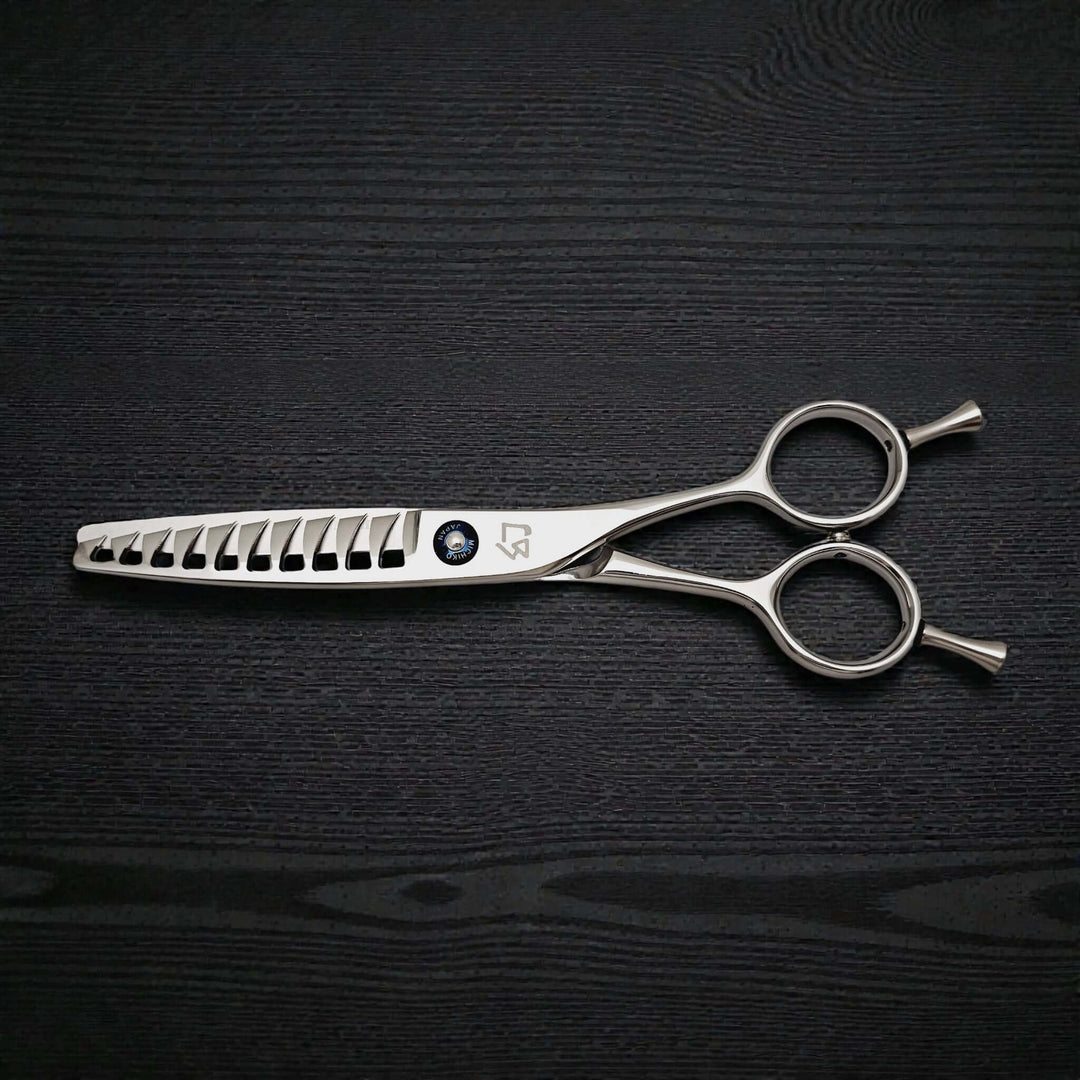 Hair cutting scissors on a black textured surface