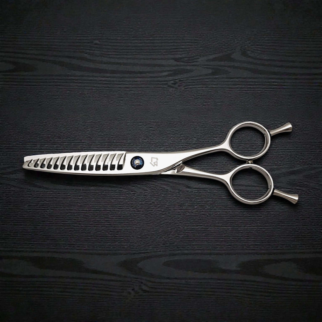 Hair texturizing shears on a black wooden surface