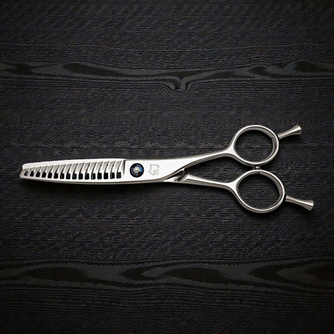 Hair cutting shears on a dark textured surface