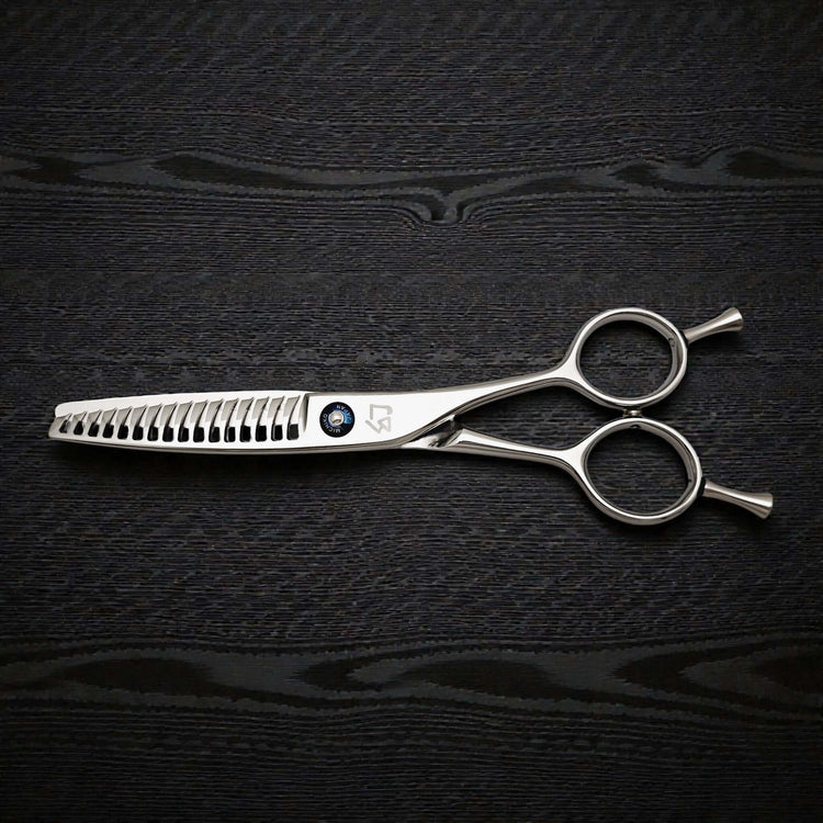 Hair cutting shears on a dark textured surface
