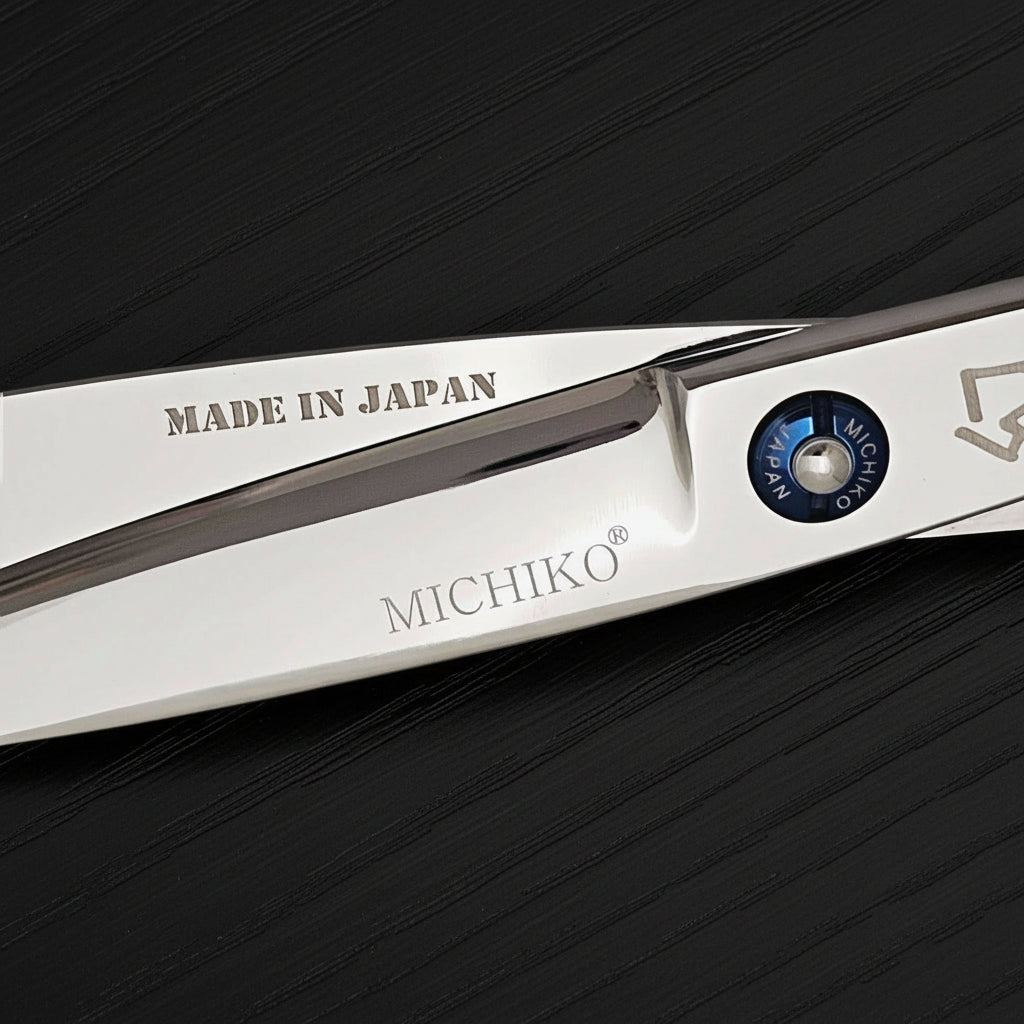 Close-up of a pair of Michiko hair shears with 'Made in Japan' text on a black background