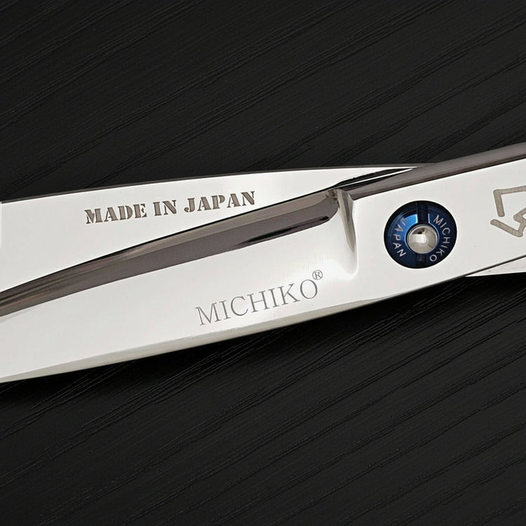 Close-up of a pair of Michiko hair shears with 'Made in Japan' text on a black background