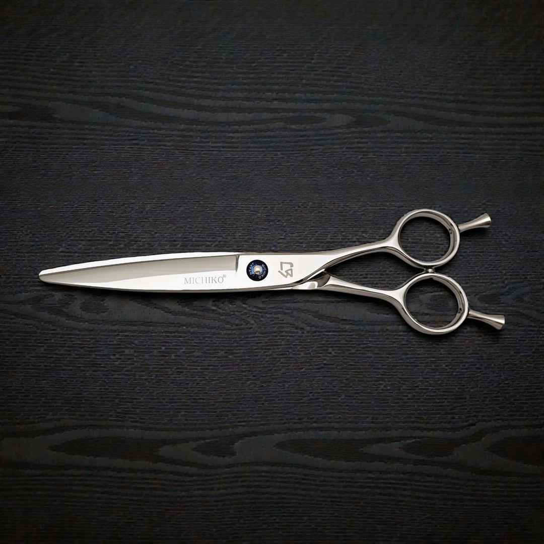 Hair cutting shears on a black textured background
