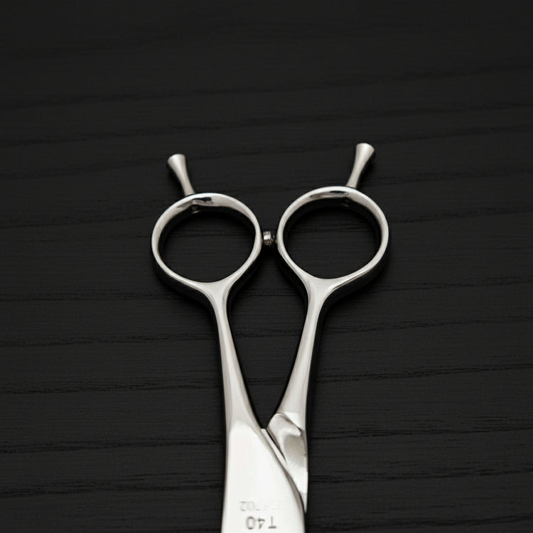 Hairdressing scissors handle on a black background