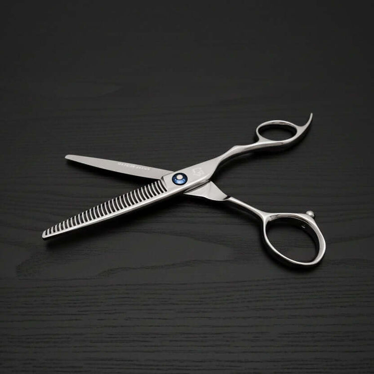 Hair cutting scissors on a black background