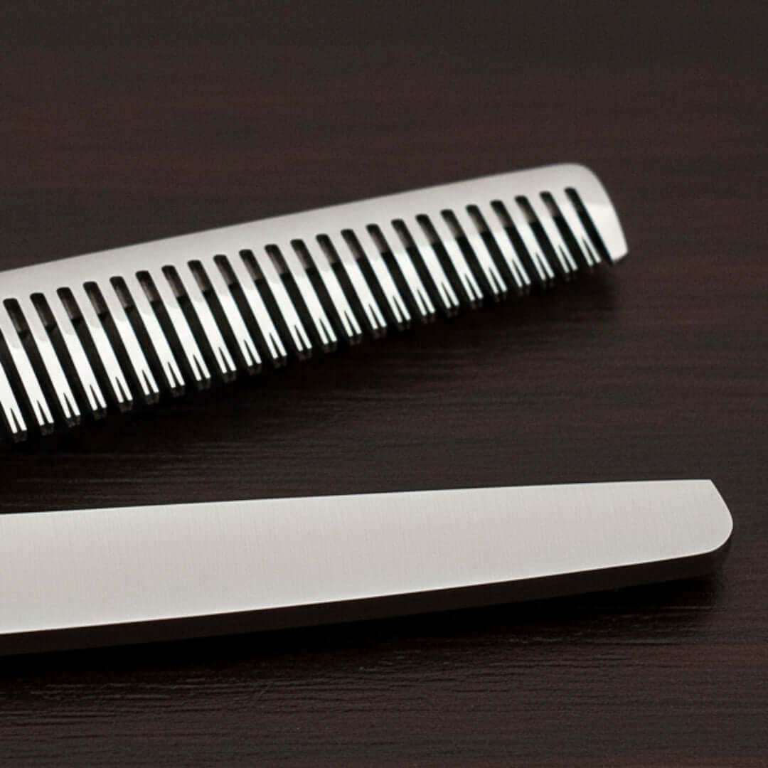 Close-up of hair thinner on a dark wooden surface