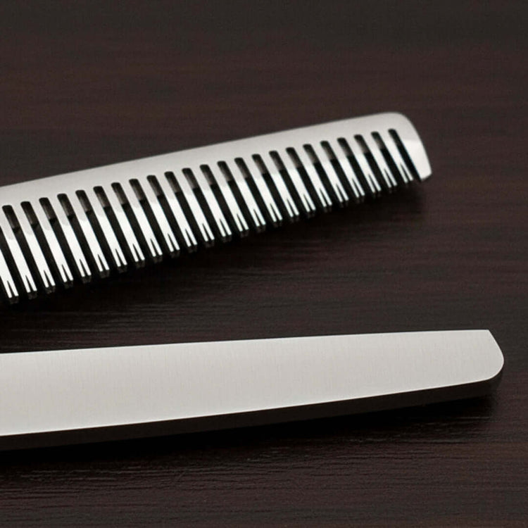 Close-up of hair thinner on a dark wooden surface