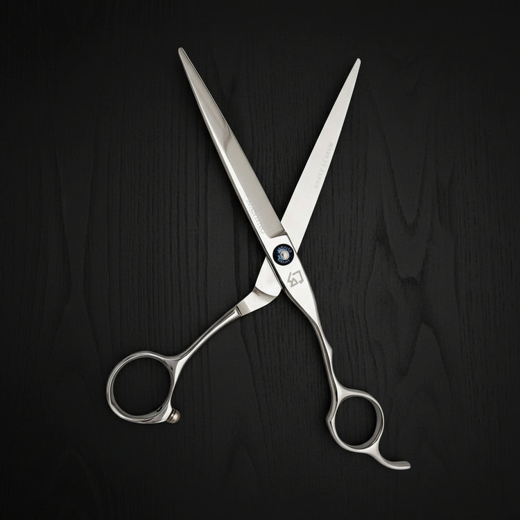 Hair-cutting scissors on a black background