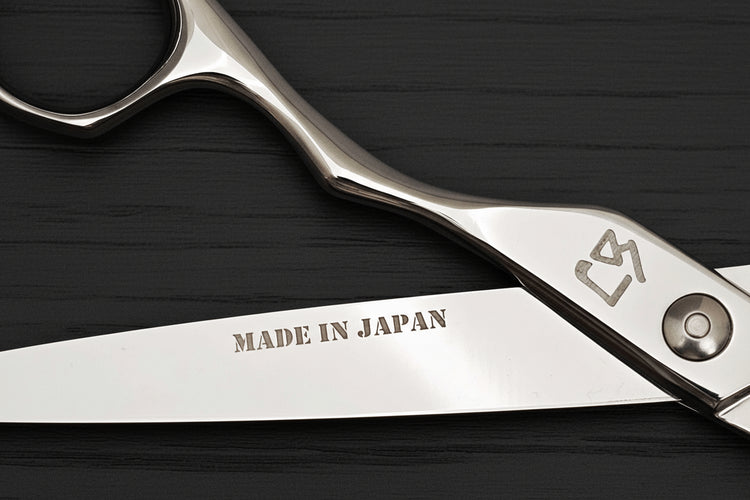 Hair shears with 'Made in Japan' engraving on a dark background