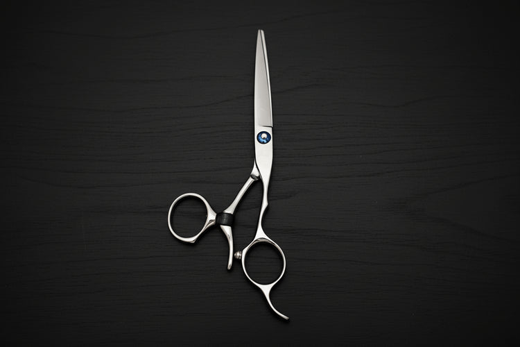 Pair of silver swivel scissors on a black background