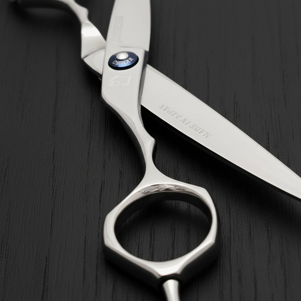 Silver hair scissors with a brand logo on a black background