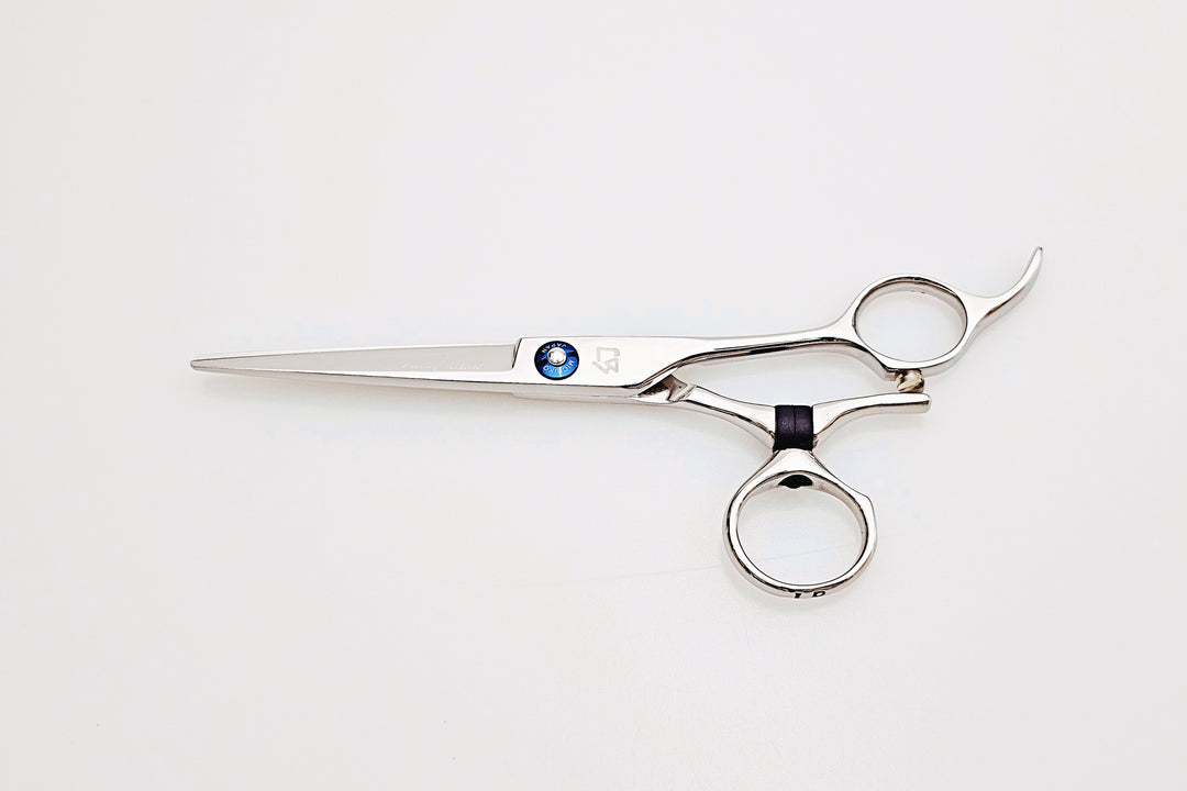 Swivel hair scissors on a marble surface