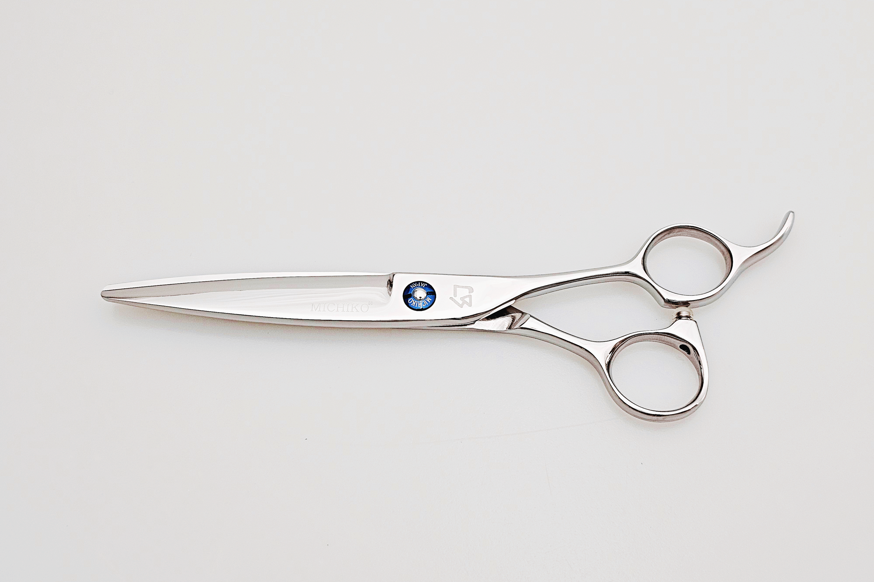 Hair scissors with a brand logo on a white background