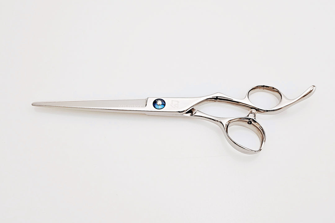 Hair scissors with a blue screw on a white background