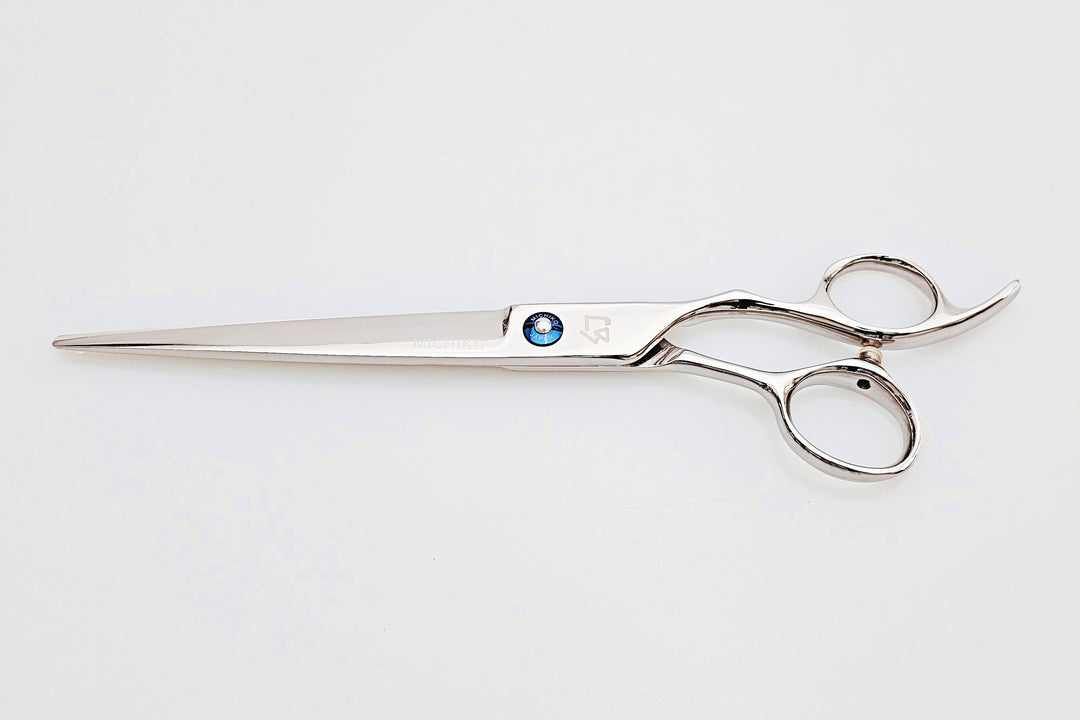 Hair scissors with a blue screw on a white background