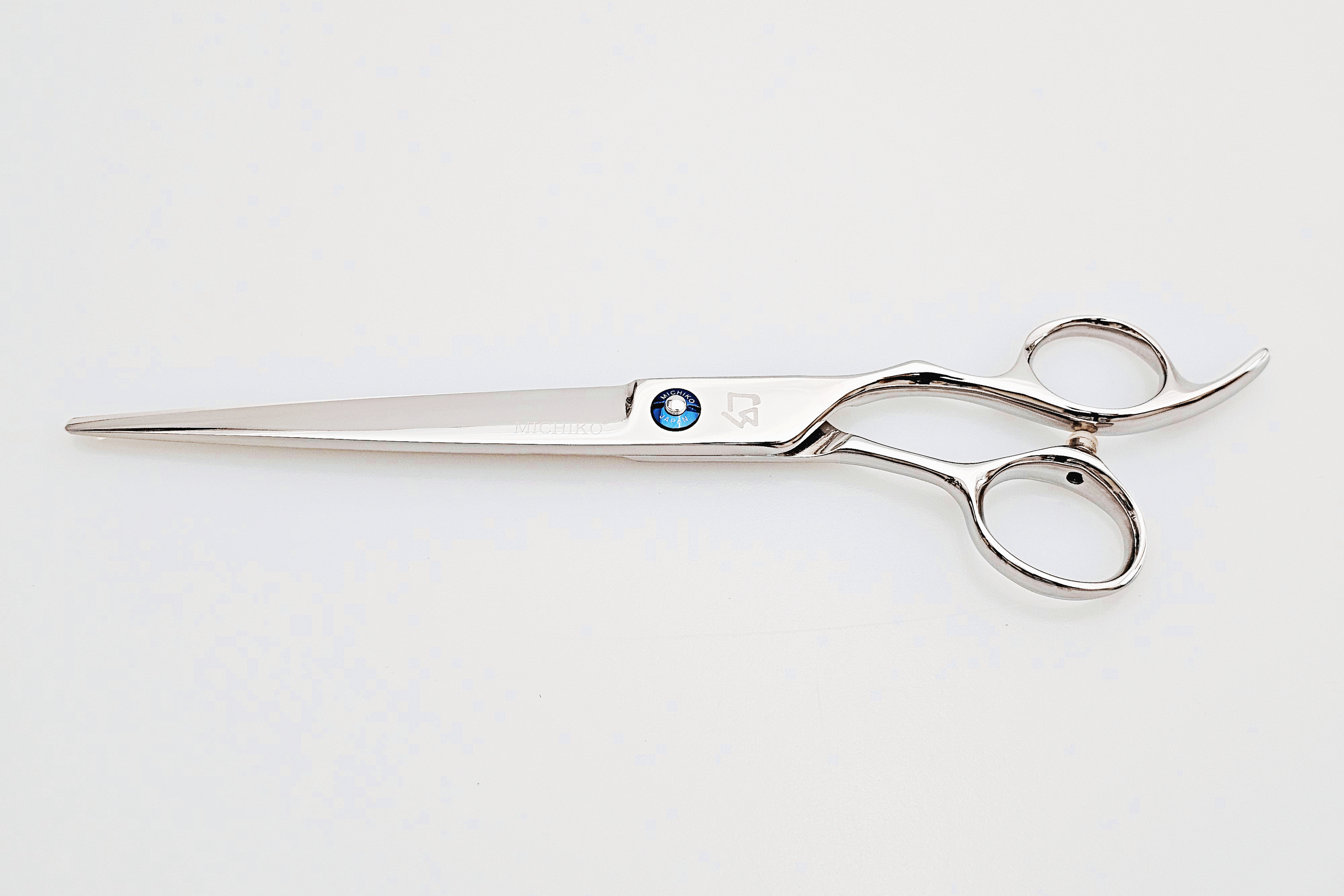 Hair scissors with a blue screw on a white background