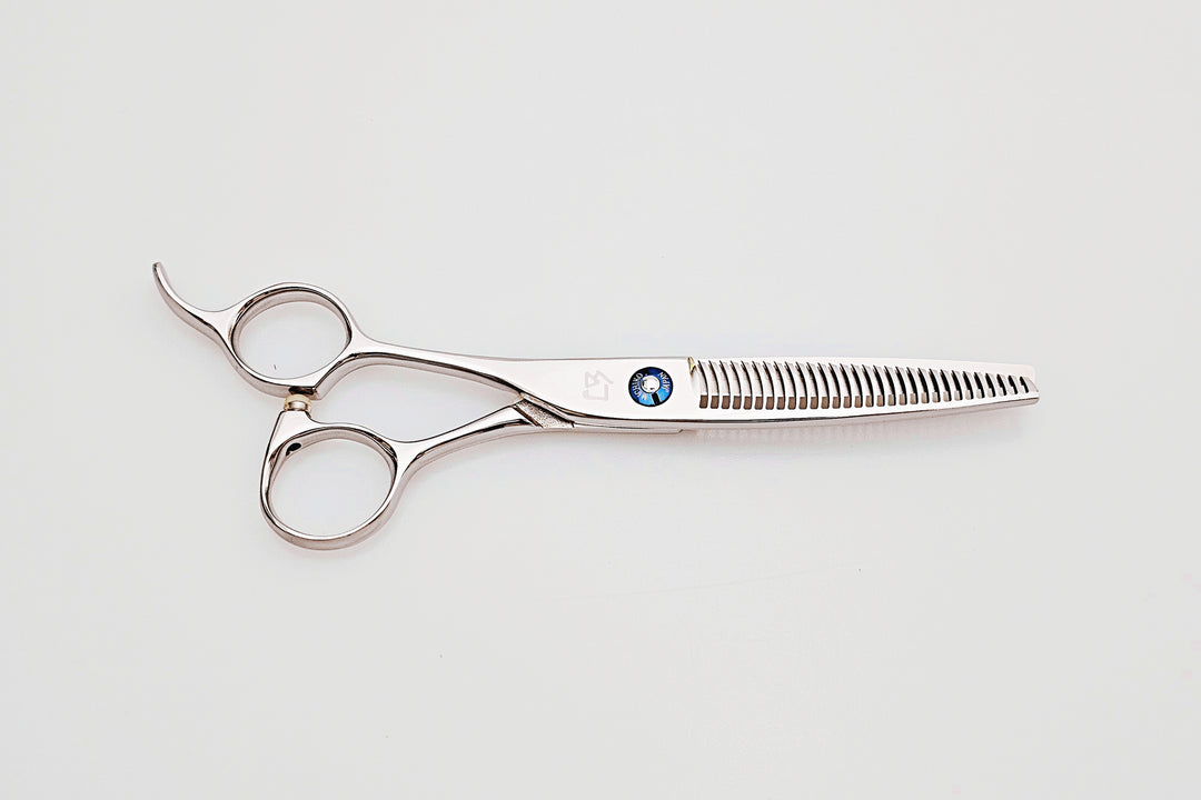 Lefty hair thinning scissors with a brand logo on a light gray background