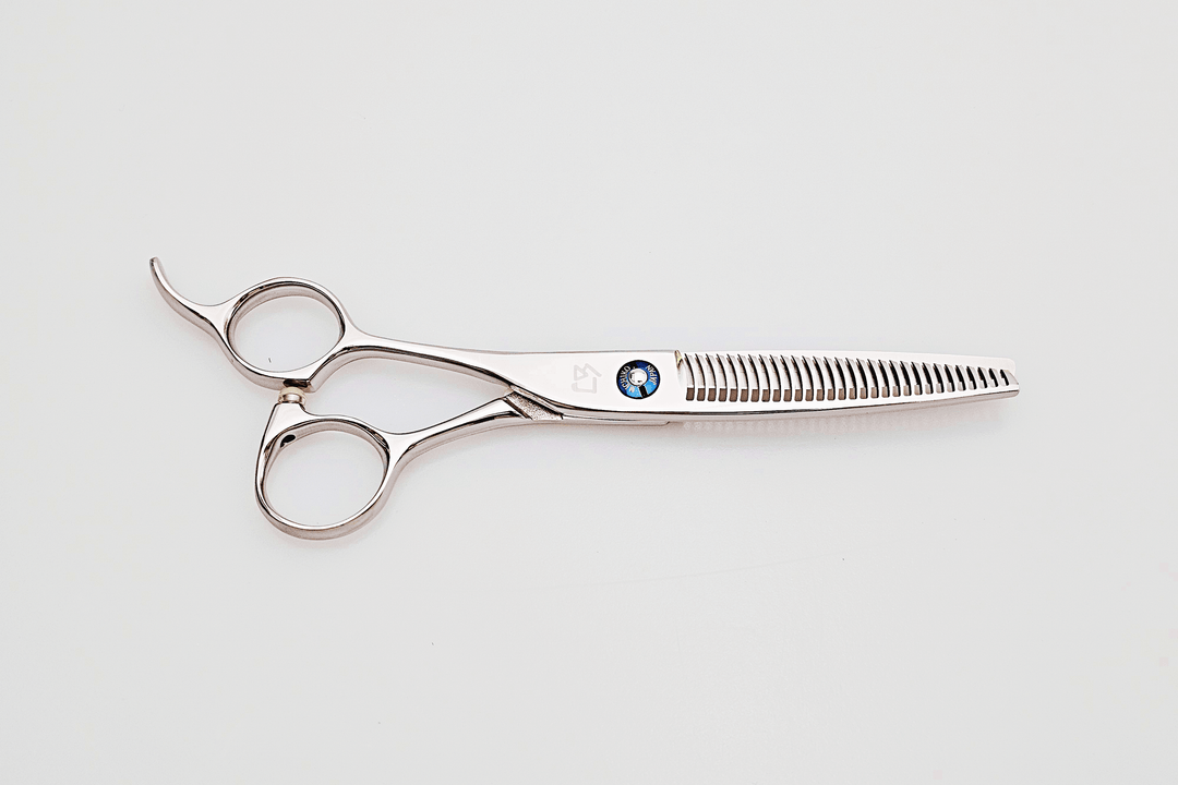 Lefty hair thinning scissors with a brand logo on a light gray background