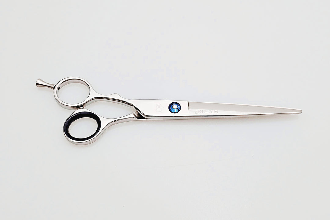 Left handed hair cutting scissors with a brand logo on a white background