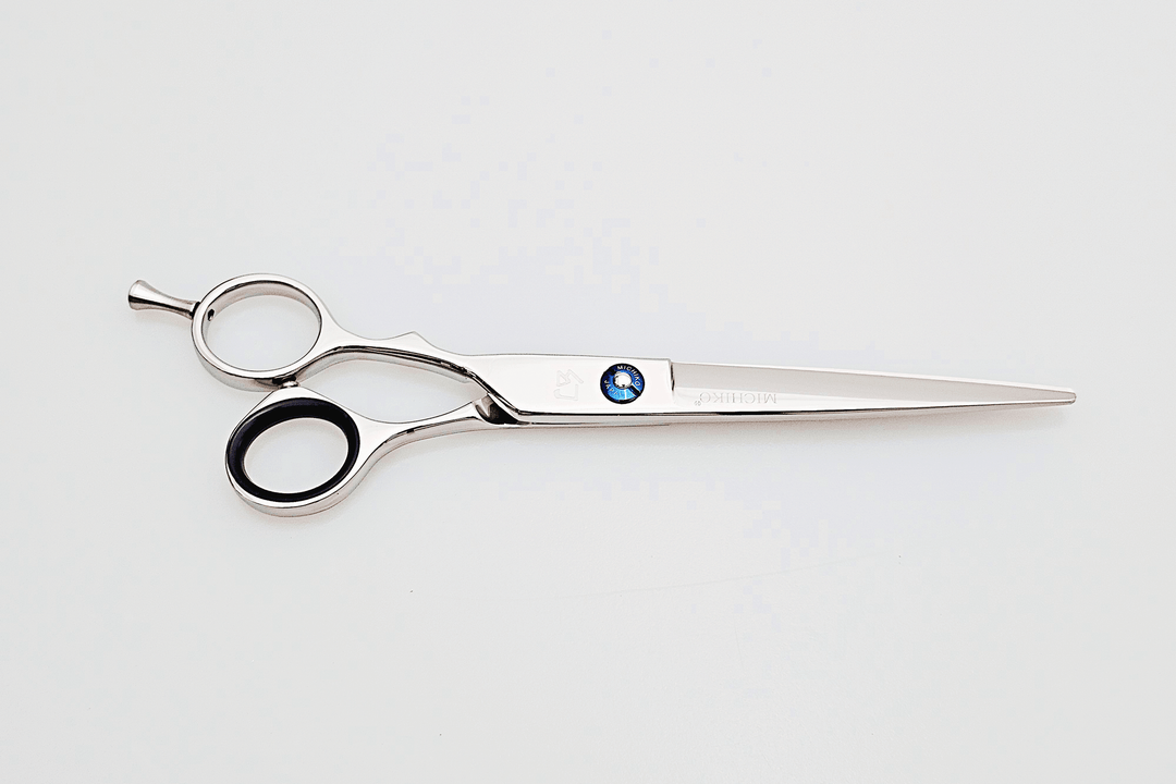 Left handed hair cutting scissors with a brand logo on a white background