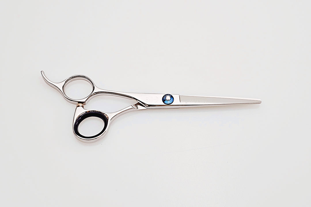 Left handed hair cutting scissors with a brand logo on a white background