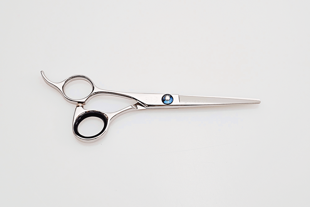 Left handed hair cutting scissors with a brand logo on a white background