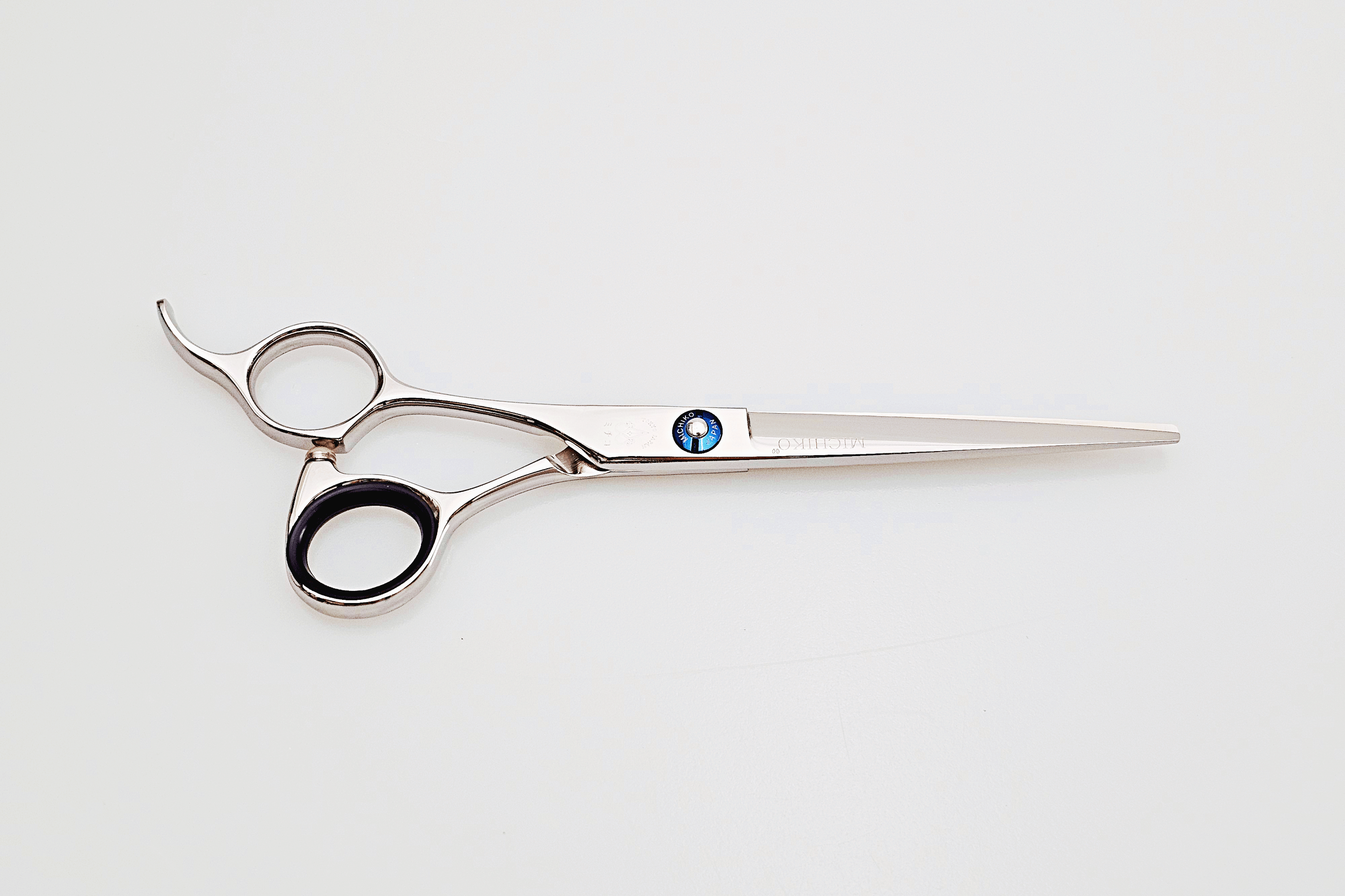 Lefty hair cutting scissors with a brand logo on a white background