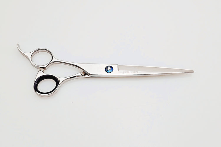Left handed hair cutting scissors on a white background