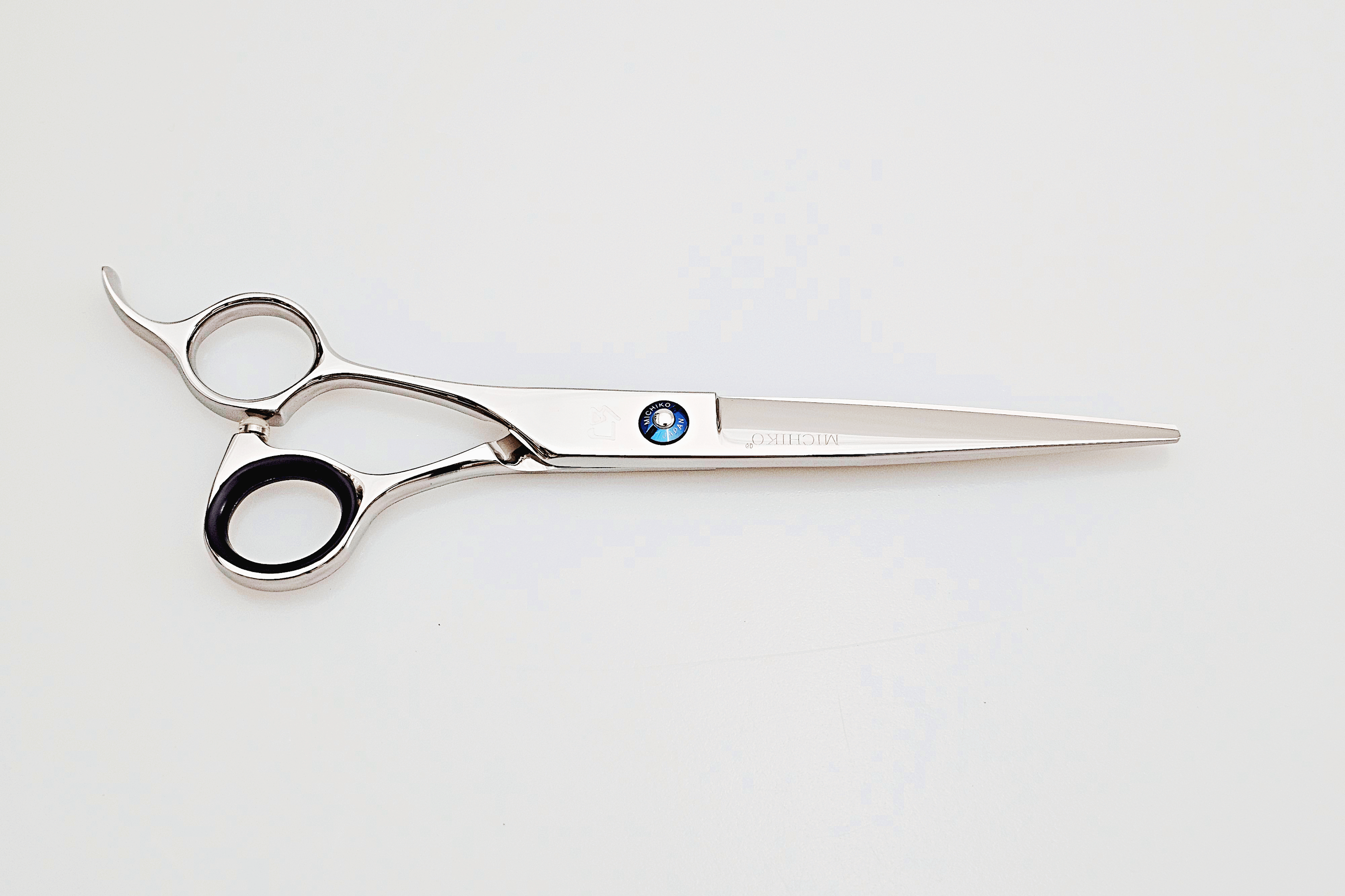 Left handed hair cutting scissors on a white background