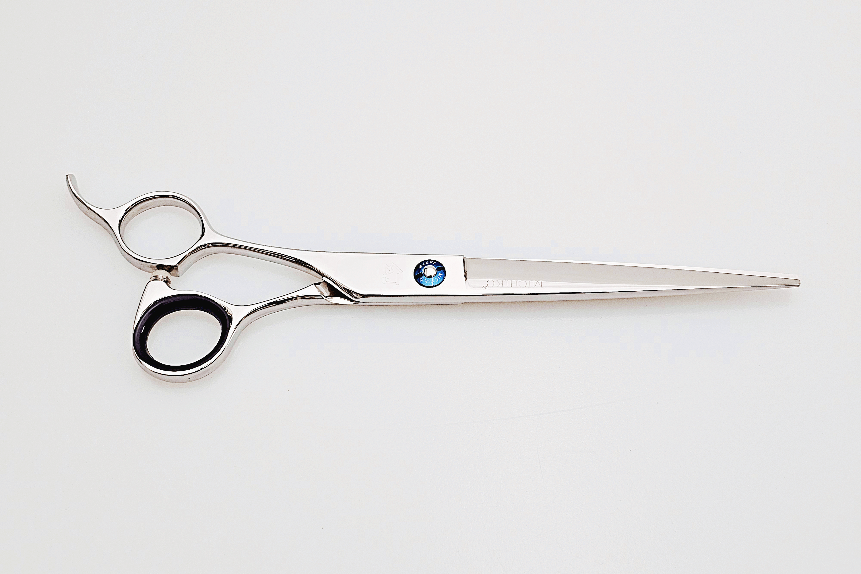 Lefty hair cutting scissors with a brand logo on a white background