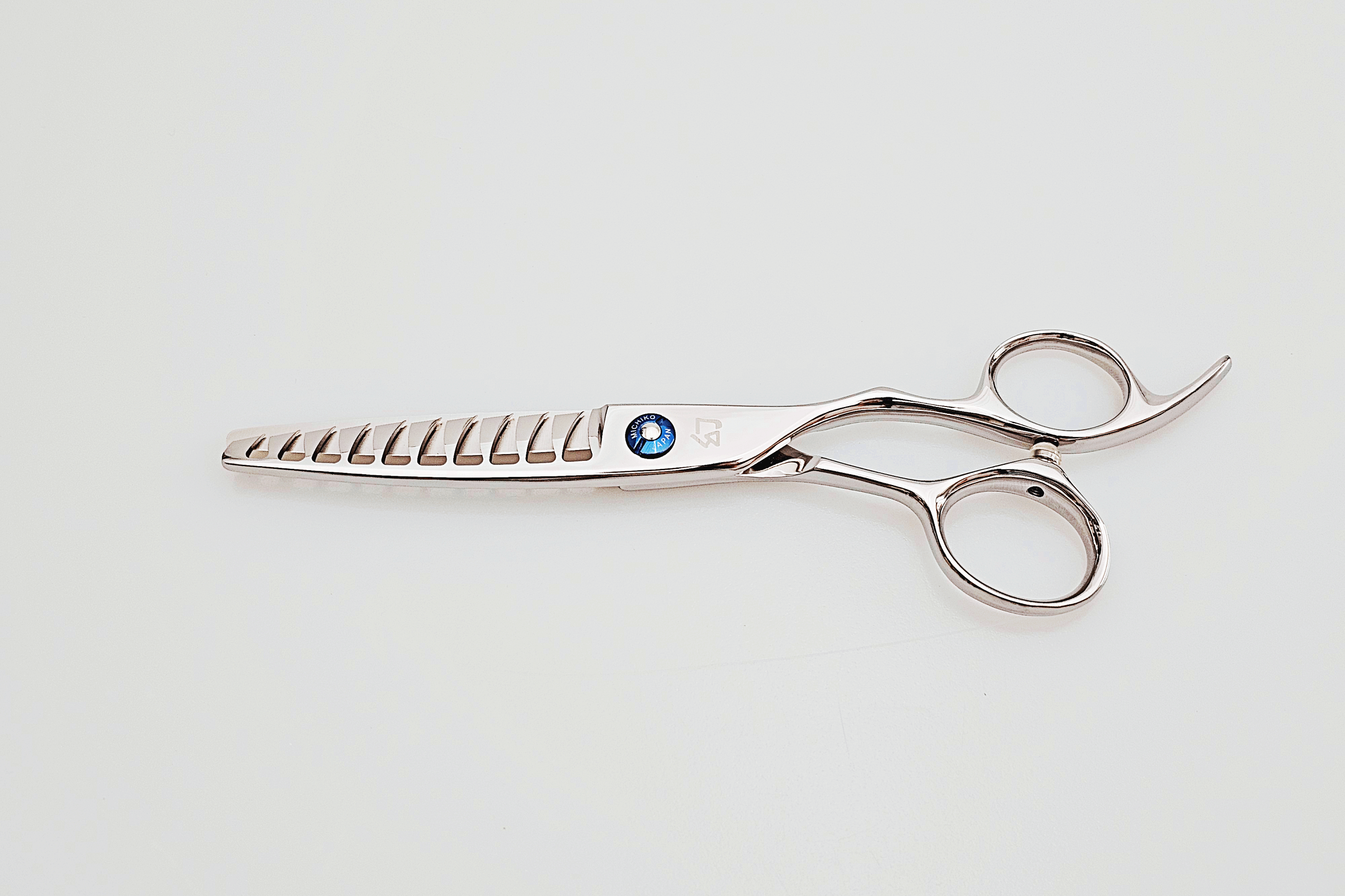 Hair texturizing scissors on a light gray backgroun