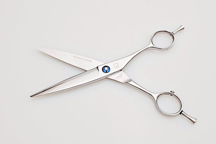 Pair of dry cut hair scissors with a visible brand logo on a white background