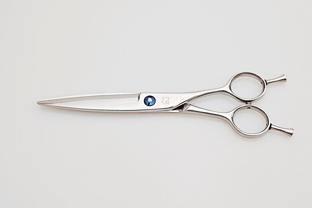 Pair of dry cut hair scissors with a visible brand logo on a white background