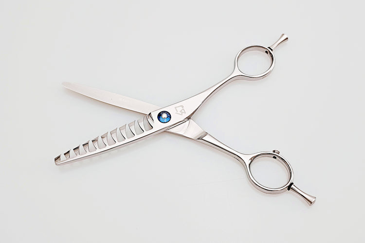 Pair of texturizing scissors on a white background