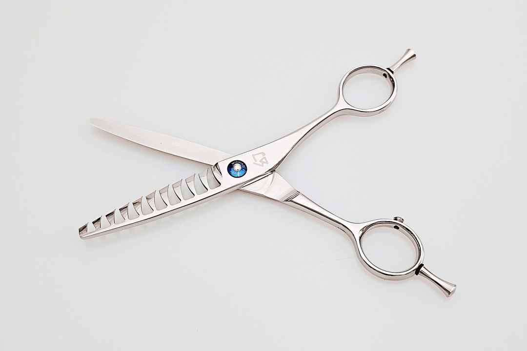 Pair of texturizing scissors on a white background