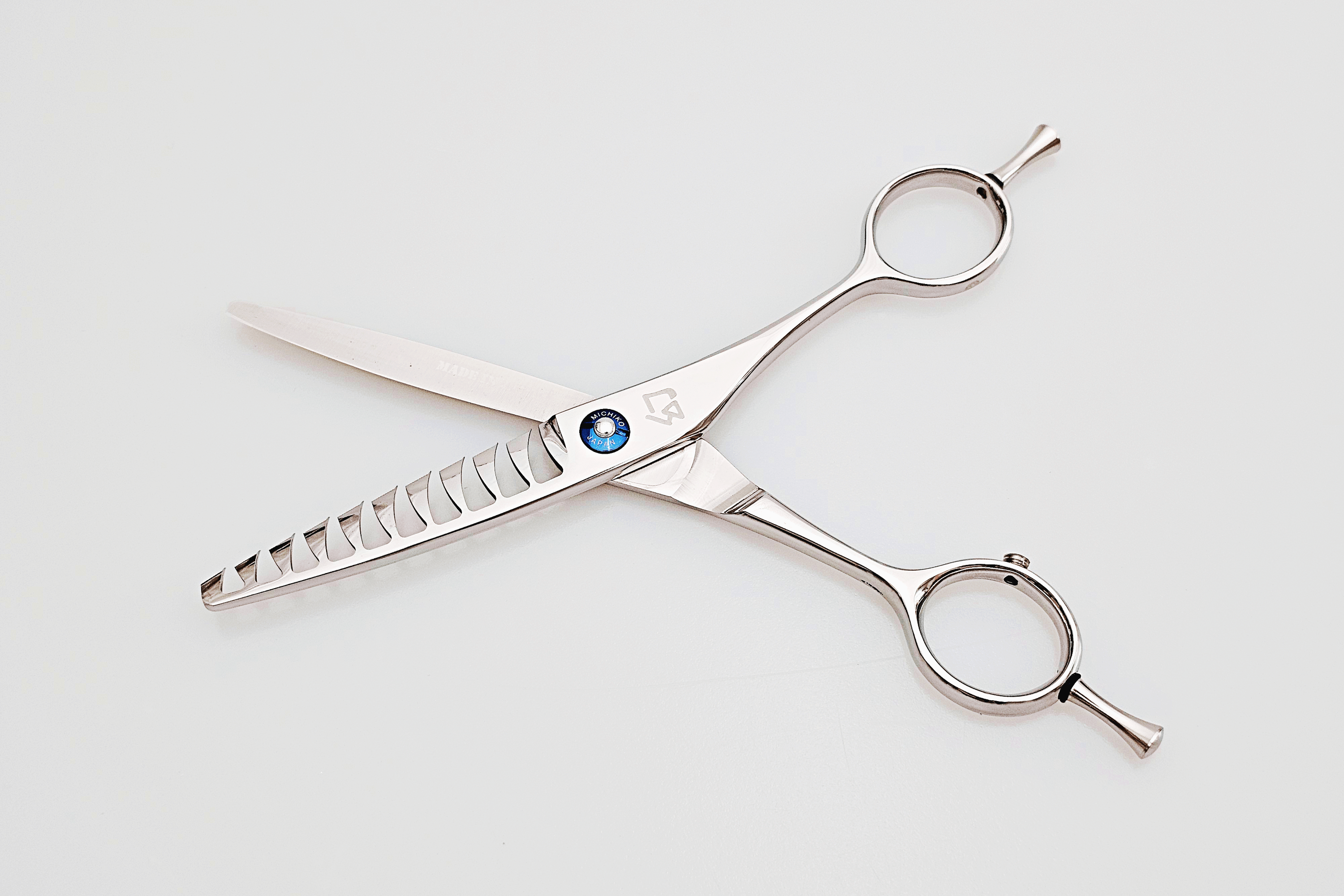 Pair of texturizing scissors on a white background