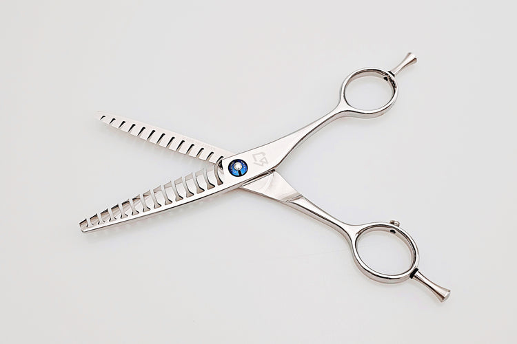 Double teeth hair texturizing scissors on a white background
