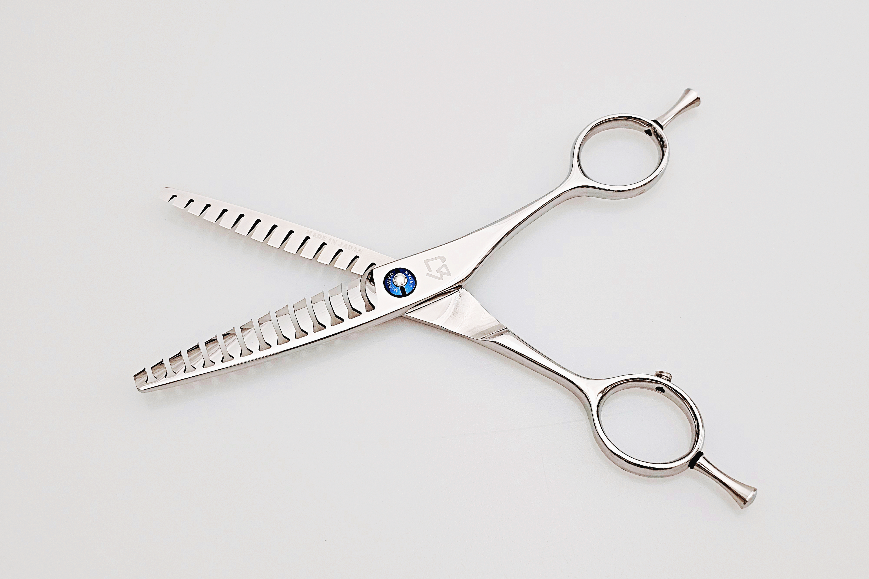 Double teeth hair texturizing scissors on a white background